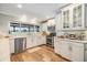 Well-lit kitchen showcasing white cabinets, stainless steel appliances, and granite countertops at 3938 Lake Joyce Dr, Land O Lakes, FL 34639