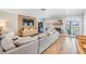 Cozy living room with a fireplace, hardwood floors, and large windows offering scenic views at 3938 Lake Joyce Dr, Land O Lakes, FL 34639