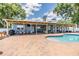 Outdoor pool and patio area featuring a covered patio with bar, dining, and lounge areas at 3938 Lake Joyce Dr, Land O Lakes, FL 34639