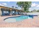 Beautiful pool and spa area with a brick patio and covered lanai for outdoor enjoyment at 3938 Lake Joyce Dr, Land O Lakes, FL 34639