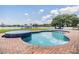 Inviting pool and spa with brick surround overlooks the tranquil lake, perfect for relaxation and entertaining at 3938 Lake Joyce Dr, Land O Lakes, FL 34639
