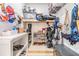 Organized storage room with shelves holding shoes, golf clubs and other sporting equipment at 3938 Lake Joyce Dr, Land O Lakes, FL 34639
