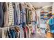 Organized walk-in closet with shelves and hanging rods, providing ample storage space at 3938 Lake Joyce Dr, Land O Lakes, FL 34639