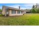 A spacious backyard features a well-maintained lawn and a view of the home's exterior with multiple windows at 4017 103Rd N Ave, Clearwater, FL 33762