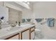 Bathroom featuring a shower/tub combo, grab bars, and a single sink with medicine cabinet at 4017 103Rd N Ave, Clearwater, FL 33762