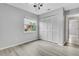 Bedroom featuring hard surface flooring and a closet with folding doors and a window at 4017 103Rd N Ave, Clearwater, FL 33762