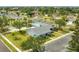 Aerial view of a community pool and bocce ball court with landscaped lawns, parking and well-maintained buildings at 4017 103Rd N Ave, Clearwater, FL 33762