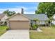 Charming single-story home with well-manicured lawn, neutral color, and a two-car garage at 4017 103Rd N Ave, Clearwater, FL 33762