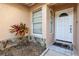 Close-up of front door with tiled entry and low maintenance landscaping at 4017 103Rd N Ave, Clearwater, FL 33762