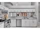 Bright kitchen features stainless steel appliances, granite countertops, and white cabinets at 4017 103Rd N Ave, Clearwater, FL 33762