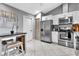 Bright, updated kitchen with stainless appliances, bar stool seating, and tiled floors at 4017 103Rd N Ave, Clearwater, FL 33762