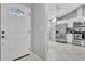 Inviting entry into the updated kitchen with stainless steel appliances and white cabinetry at 4017 103Rd N Ave, Clearwater, FL 33762