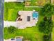Overhead view of the home's roof, screened pool, solar panels, and expansive lawn at 4615 Cozzo Dr, Land O Lakes, FL 34639