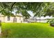 Expansive backyard features mature trees and an enclosed lanai, offering privacy and space at 4615 Cozzo Dr, Land O Lakes, FL 34639