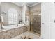 Bathroom features a large garden tub, tiled walk-in shower and a commode at 4615 Cozzo Dr, Land O Lakes, FL 34639