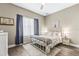 Neutral bedroom featuring a white metal bedframe and a hardwood floor at 4615 Cozzo Dr, Land O Lakes, FL 34639