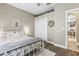 Neutral bedroom featuring a white metal bedframe, a full closet and an en suite entrance at 4615 Cozzo Dr, Land O Lakes, FL 34639