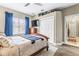 Bedroom features a wood bed frame, ceiling fan and an en suite bathroom at 4615 Cozzo Dr, Land O Lakes, FL 34639