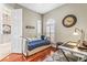 Cozy room featuring a daybed, hardwood floors, and arched window with shutters at 4615 Cozzo Dr, Land O Lakes, FL 34639