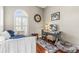 Bedroom featuring a daybed, hardwood floors, an arched window with shutters and a modern desk at 4615 Cozzo Dr, Land O Lakes, FL 34639