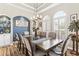 Elegant dining room with decorative windows, wood flooring, and stylish furniture at 4615 Cozzo Dr, Land O Lakes, FL 34639