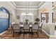 Formal dining room with a large table, stylish chairs, wood floors and decorative lighting at 4615 Cozzo Dr, Land O Lakes, FL 34639