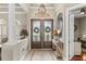 Bright foyer featuring decorative double doors, a tile floor, and an elegant chandelier at 4615 Cozzo Dr, Land O Lakes, FL 34639