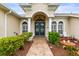 Front entrance with a decorative double door, decorative plants, and a cozy seating area at 4615 Cozzo Dr, Land O Lakes, FL 34639