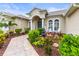 Inviting front entrance with a fountain, lush landscaping, and comfortable seating area at 4615 Cozzo Dr, Land O Lakes, FL 34639