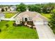 Beautiful landscaped single-Gathering home with a well-manicured lawn and front-facing garage at 4615 Cozzo Dr, Land O Lakes, FL 34639