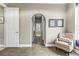 Hallway features wood-look floors, an archway and a cozy chair near the window at 4615 Cozzo Dr, Land O Lakes, FL 34639