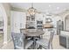 Eat-in kitchen features stainless appliances, tile backsplash and a wine rack above the bar area at 4615 Cozzo Dr, Land O Lakes, FL 34639