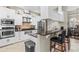 Modern kitchen features granite countertops, stainless steel appliances, and breakfast bar seating at 4615 Cozzo Dr, Land O Lakes, FL 34639