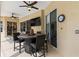 Cozy lanai featuring a ceiling fan, outdoor dining set, and television for outdoor living at 4615 Cozzo Dr, Land O Lakes, FL 34639