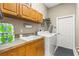 Bright laundry room with cabinets, sink, washer, and dryer for convenient chores at 4615 Cozzo Dr, Land O Lakes, FL 34639