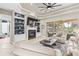 Elegant living room featuring a fireplace, built-in shelving, and sliding glass doors to the outdoor area at 4615 Cozzo Dr, Land O Lakes, FL 34639