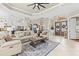 Spacious living room showcasing neutral furniture, an open floor plan, and decorative ceilings at 4615 Cozzo Dr, Land O Lakes, FL 34639