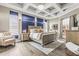 Main bedroom with a decorative tray ceiling, wood-look floors and blue accent wall at 4615 Cozzo Dr, Land O Lakes, FL 34639