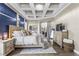 Spacious main bedroom offers a decorative tray ceiling, wood-look floors and a ceiling fan at 4615 Cozzo Dr, Land O Lakes, FL 34639