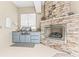 Beautiful outdoor kitchen with stone fireplace, grill, and prep area for al fresco dining at 4615 Cozzo Dr, Land O Lakes, FL 34639