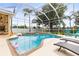Sparkling in-ground pool with a screened enclosure and lounging area, perfect for summer fun at 4615 Cozzo Dr, Land O Lakes, FL 34639