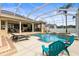 Inviting screened-in pool and spa area with ample seating for relaxing and entertaining by the water at 4615 Cozzo Dr, Land O Lakes, FL 34639