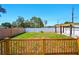 Backyard featuring a wooden deck, white fence, and pergola at 5030 9Th S Ave, Gulfport, FL 33707