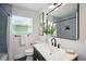 Bathroom featuring a marble vanity, modern fixtures, and a large mirror at 5030 9Th S Ave, Gulfport, FL 33707