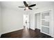 Bright bedroom boasts hardwood floors, ceiling fan, closet with sliding doors at 5030 9Th S Ave, Gulfport, FL 33707