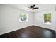 Cozy bedroom with natural light from two windows and beautiful wood-look flooring at 5030 9Th S Ave, Gulfport, FL 33707