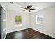 Bright bedroom features two windows, hardwood floors, and a ceiling fan at 5030 9Th S Ave, Gulfport, FL 33707