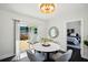 Light-filled dining area with a modern round table, access to the deck, and views to the bedroom at 5030 9Th S Ave, Gulfport, FL 33707