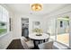 Bright dining room with a round table, stylish chairs, and sliding glass doors to outdoor deck at 5030 9Th S Ave, Gulfport, FL 33707