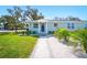 Beautiful single-story house featuring a well-maintained lawn, nicely landscaped entrance, and a freshly painted facade at 5030 9Th S Ave, Gulfport, FL 33707